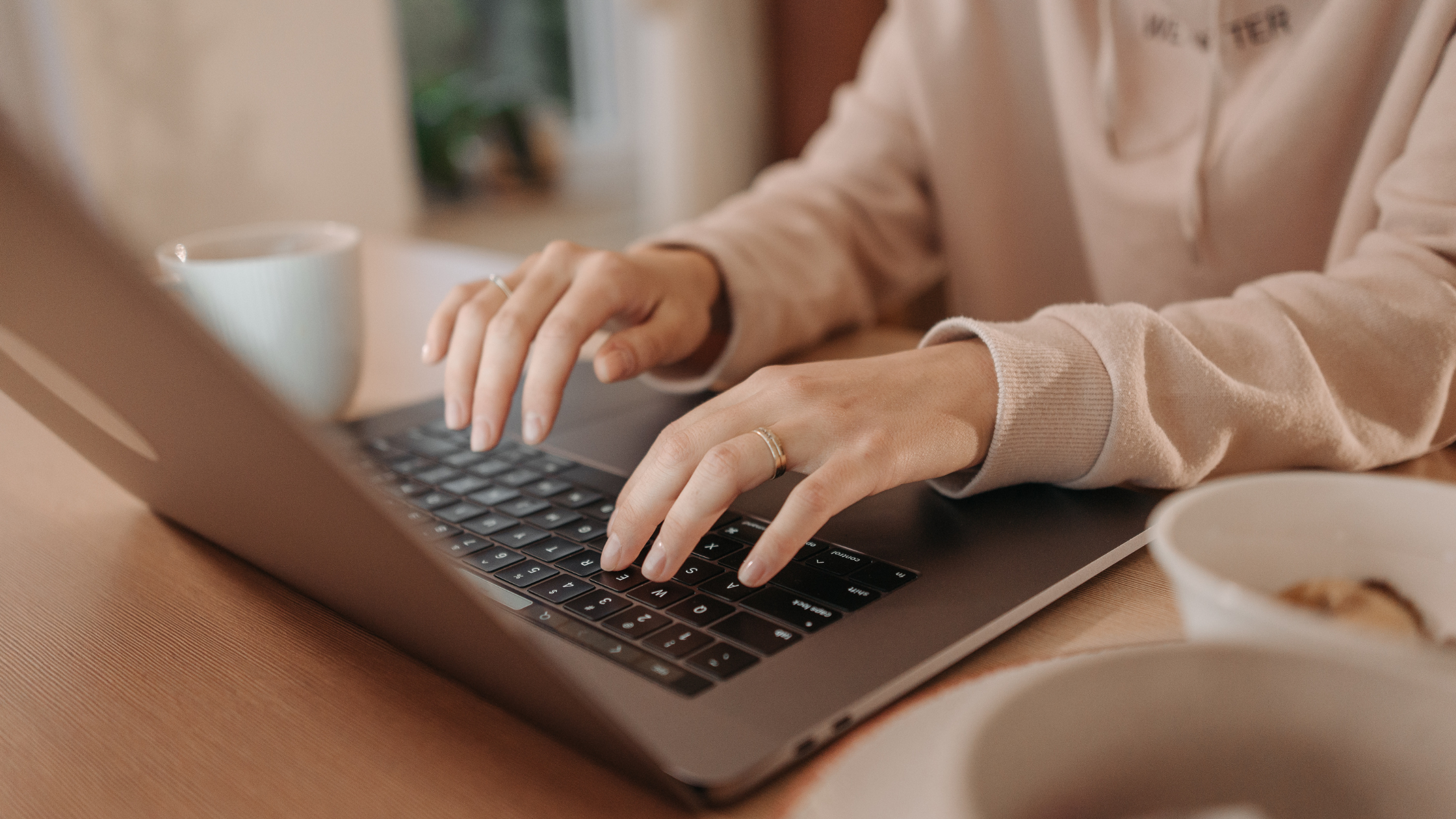 Woman typing on a laptop