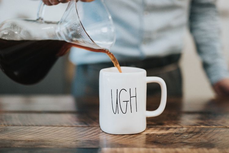 Person pouring coffee into mug with 'ugh' text
